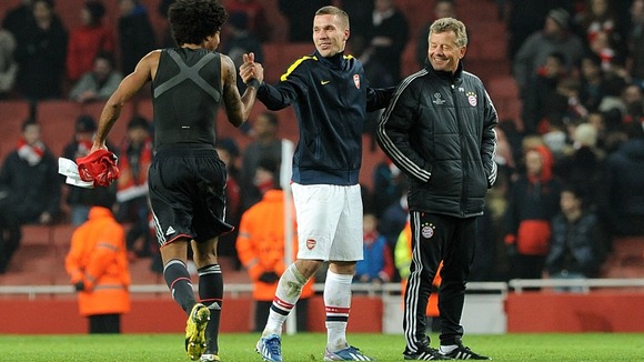 Lukas Podolski musters a smile to greet old friends from Bayern Munich
