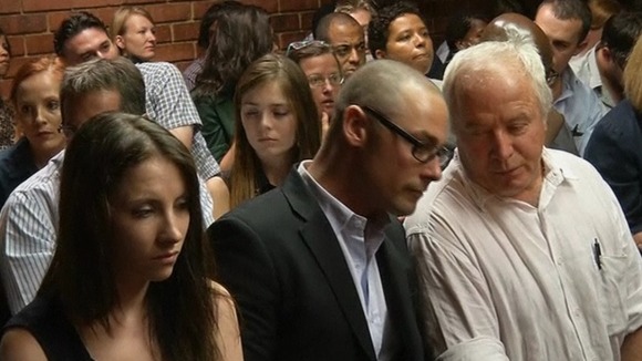 From left: Oscar Pistorius' sister Aimee, brother Carl and father Henke in the courtroom