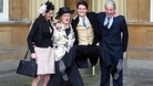 Jumping for joy: Olympic Gold Medalist Peter Wilson with his parents and girlfriend at Buckingham Palace