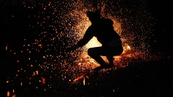 Vietnamese man from the Pa Then minority group jumps into a fire