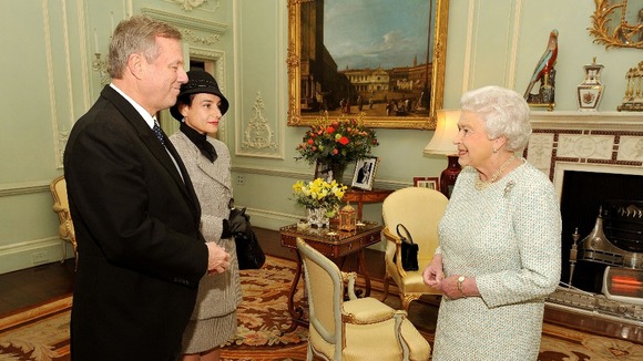 The Queen with the High Commissioner of Australia. In the background an electric fire.