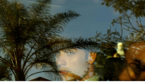 The athlete, visible behind the car's tinted window, was today granted bail 