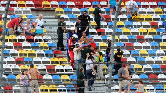 Emergency workers carry a fan from the Daytona circuit stands 