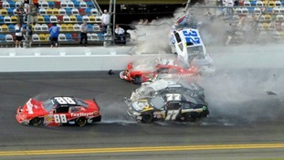 NASCAR driver Kyle Larson (32) and his Chevrolet end up in the fence during the final lap crash