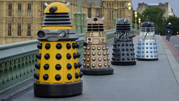 Four generations of Daleks crossing Westminster Bridge in London