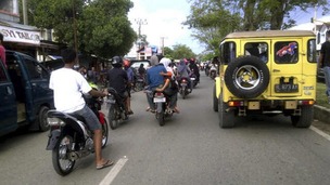 People riding motorbikes and cars packed the street in Banda Aceh after a strong earthquake struck Indonesia