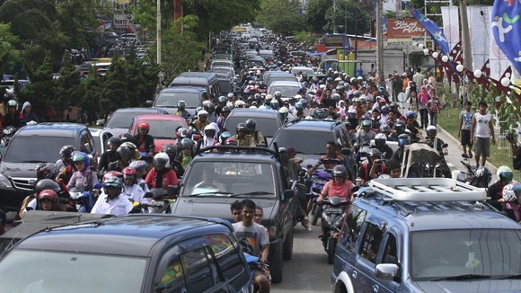 People riding motorbikes and cars packed the street in Banda Aceh after a strong earthquake struck Indonesia