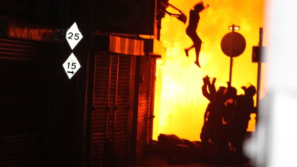 Monika Konczyk leaping from her home after a blaze was started at nearby House of Reeves furniture store in August last year.
