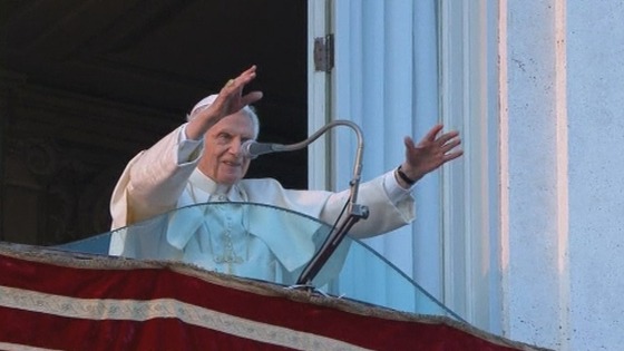 Pope Benedict XVI waves to the cheering crowds.