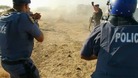 Police fire at striking miners outside a South African mine owned by Lonmin's of London