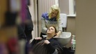 Lady washes hair in a salon