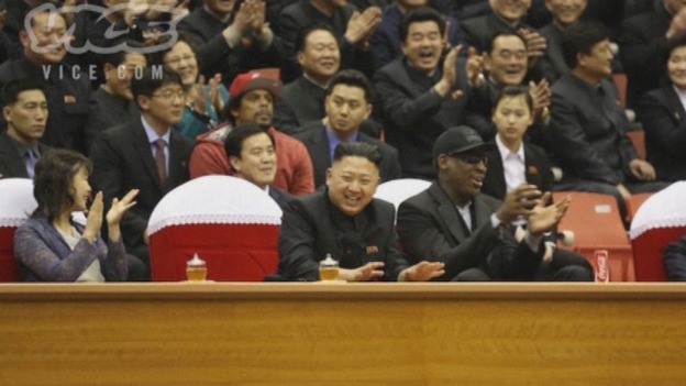 Kim Jong-un laughs with Dennis Rodman while watching a basketball game in Pyongyang.