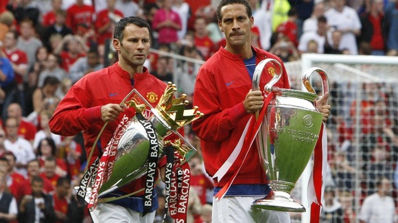 Manchester United's Ryan Giggs (left) and Rio Ferdinand with the Permier League and Champions League trophies in 2008.