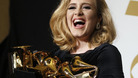 Singer Adele holds her six Grammy Awards at the 54th annual Grammy Awards in Los Angeles