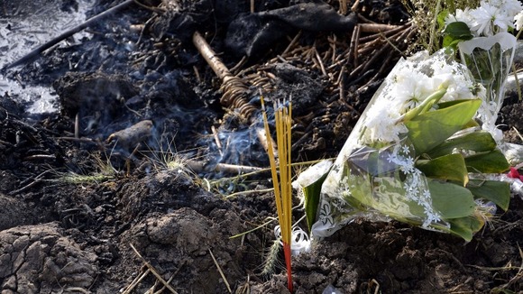 Flowers and incense are laid at the site of the hot air balloon crash in Luxor, Egypt