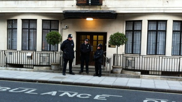 Police officers stand guard outside the King Edward VII Hospital