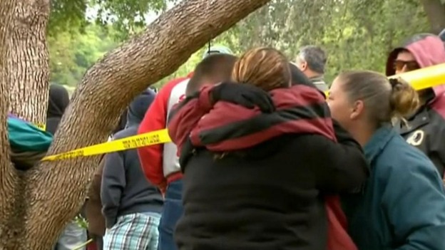 Neighbours and relatives console each other in Tampa, Florida