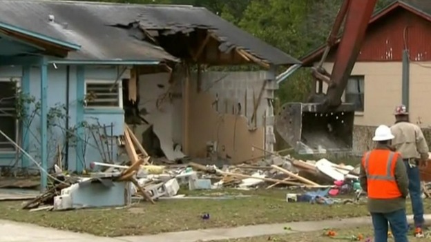 The bull dozer takes apart the property