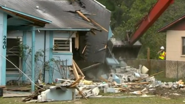 Officials say the building needs to be demolished into the hole because of safety concerns