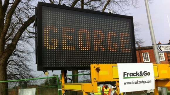 Electronic signs have been placed alongside a mock drilling rig.