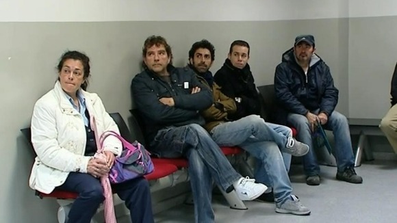 People wait to be seen at an unemployment office in Spain