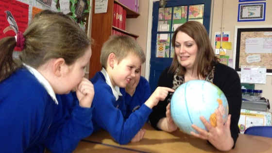 Joshua looking at the globe 