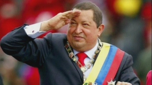 Hugo Chavez salutes during a military parade