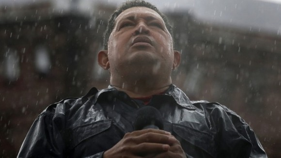 Hugo Chavez speaks in the rain during his closing campaign rally in Caracas in October 2012