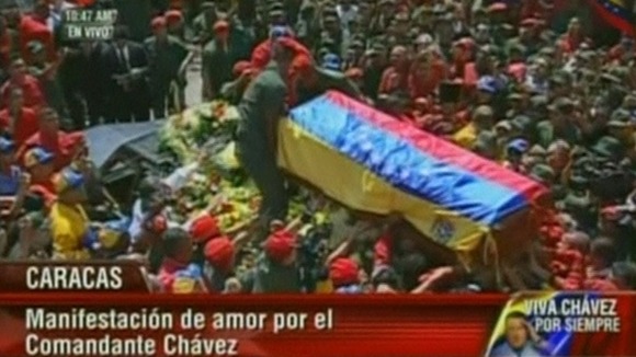Hugo Chavez's casket is loaded onto the hearse before being driven through the streets of Caracas