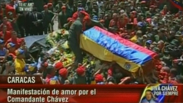 Hugo Chavez's casket is loaded onto the hearse before being driven through the streets of Caracas