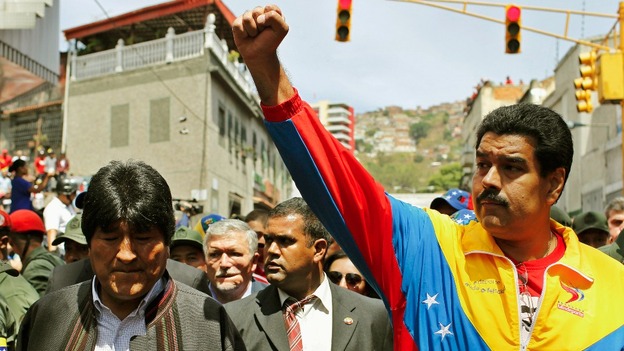 Venezuela's Vice President Nicolas Maduro (R) and Bolivia's President Evo Morales join the mourners in the streets of Caracas