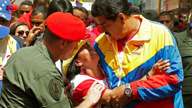 Venezuela's Vice President Nicolas Maduro consoles a mourner