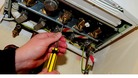 A plumber working on a gas boiler.