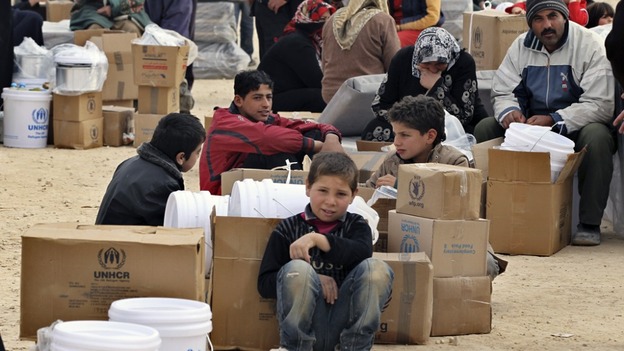 Newly arrived Syrian refugees wait to receive aid and rations at Al-Zaatri refugee camp in the Jordanian city of Mafraq in January