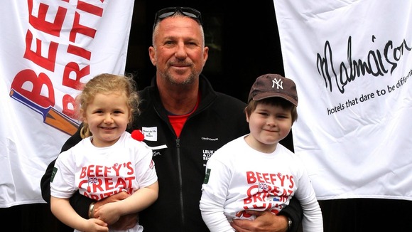 Sir Ian Botham holds Rebecca Foley and Ben Magee as he starts the first leg of his charity walk.