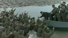 Soldiers cheer Kim Jong-un as he leaves the military base