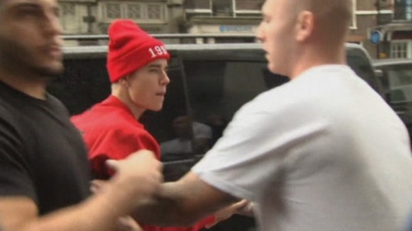 Bodyguards hold Justin Bieber back