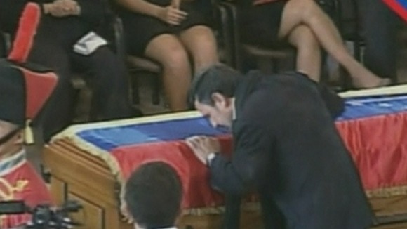 Iran's President Mahmoud Ahmadinejad kisses the coffin