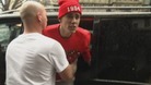 A bodyguard restrains Justin Bieber as he exchanges expletives with a photographer