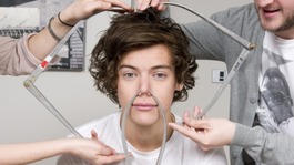Harry Styles being measured for his waxwork at Madame Tussauds