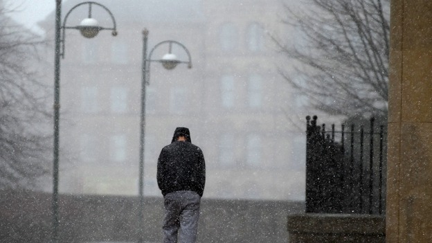 A man battles against the weather conditions in Bradford today.