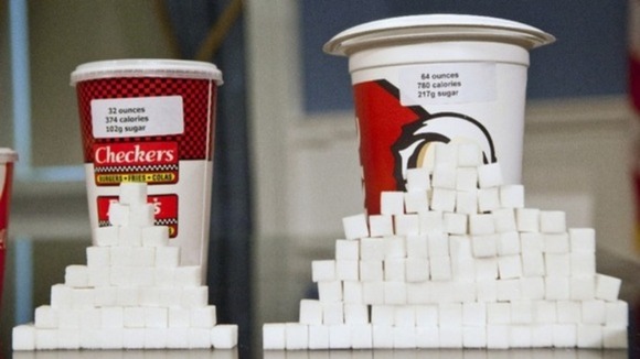 Soft drink cups sized at 32 ounces and 64 ounces are displayed at a news conference at City Hall in New York