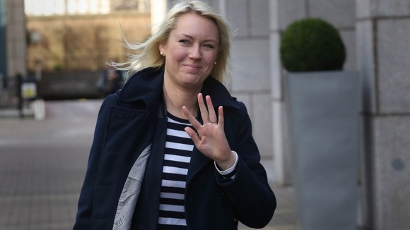 Stella English waves to photographers as she arrives at East London Tribunal Courts