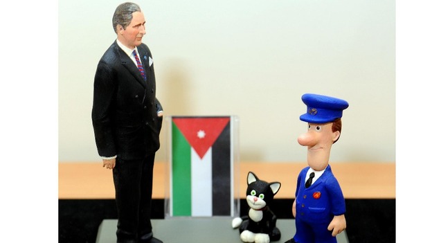 Prince Charles was presented with a model featuring himself, Postman Pat and his black and white cat Jess