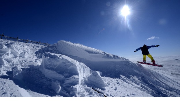 A snow boarder makes a jump at the Yad Moss ski slope in Cumbria near Alston.