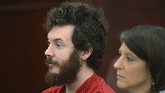 James Holmes listens with public defender Tamara Brady at his arraignment in Centennial, Colorado