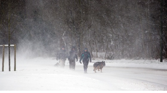 People walk in the snow near Bolney, West Sussex.