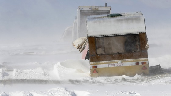 An abandoned caravan is buffeted by winds and drifting snow on the South Downs near Brighton 