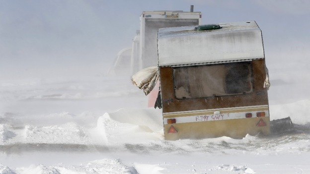 An abandoned caravan is buffeted by winds and drifting snow on the South Downs near Brighton 