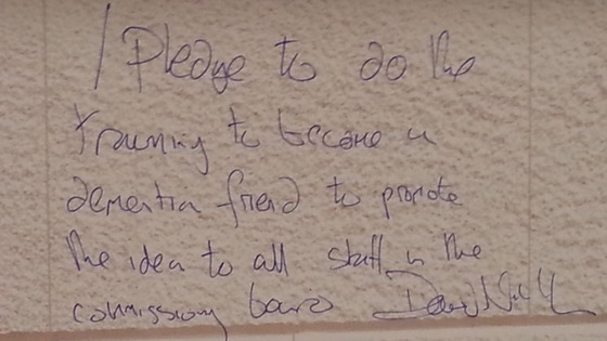 Sir David Nicholson wrote on a wall to promise to training to become 'a dementia friend'